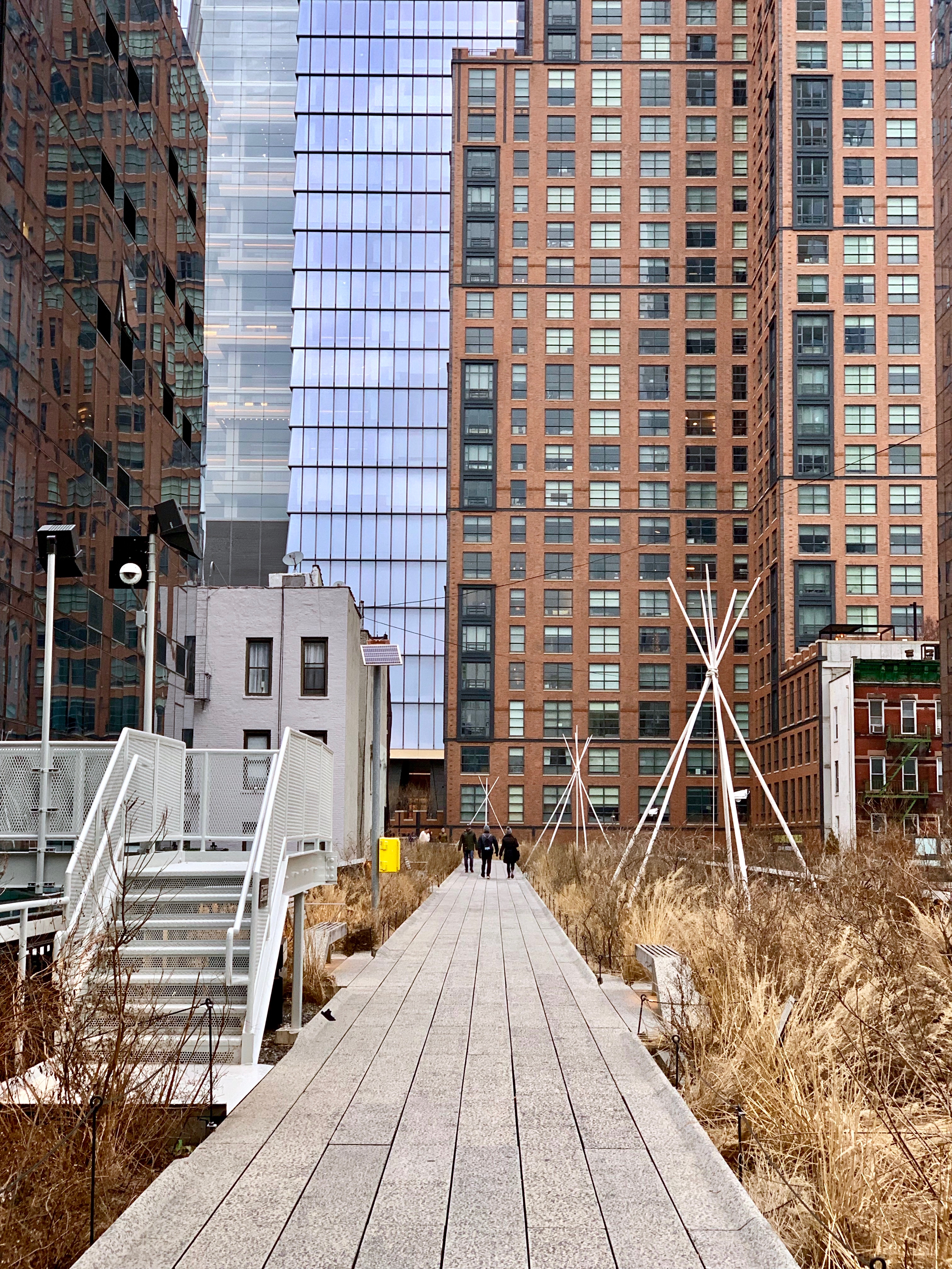 Walking the <a href="https://www.thehighline.org/">High Line</a>, with a view towards the <a href="https://www.hudsonyardsnewyork.com/about/building-hudson-yards/">Hudson Yards development</a>.